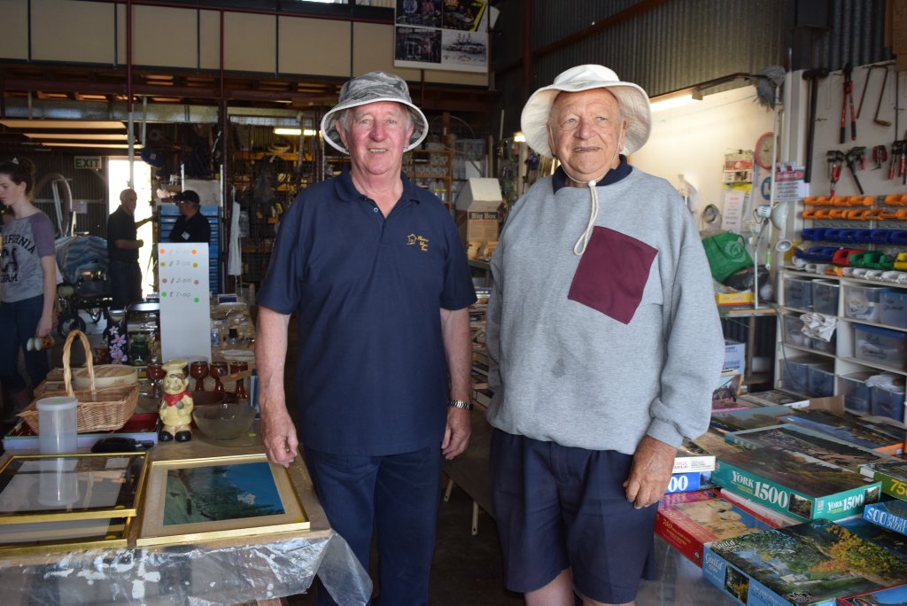 Warwick Men's Shed funds manager Neil Sims and William Smith with an assortment of the bargains at the garage sale.